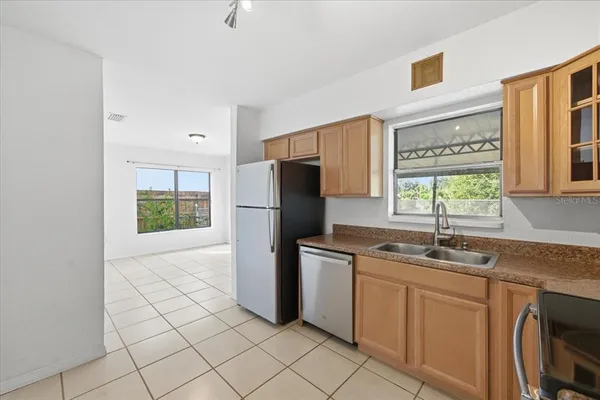 a kitchen with stainless steel appliances granite countertop a refrigerator sink and microwave