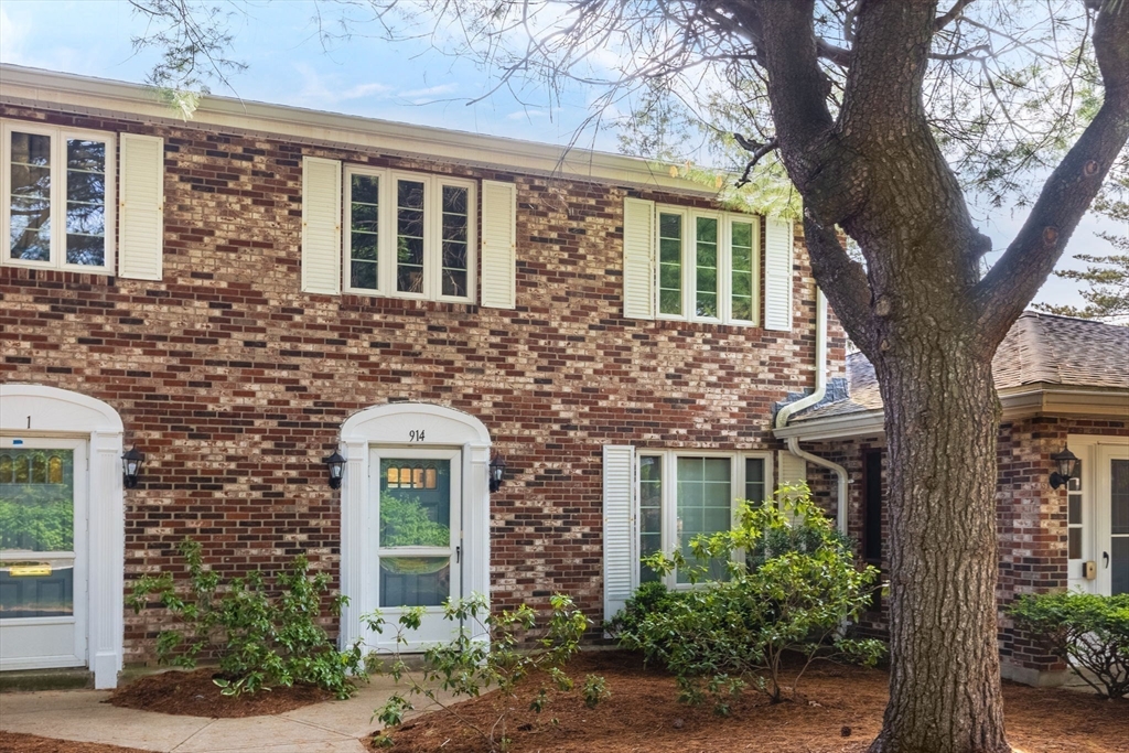910 Edgell Road, Unit 914A Framingham, MA 01701 - Photo 1 of 22 front view of a brick house with a tree