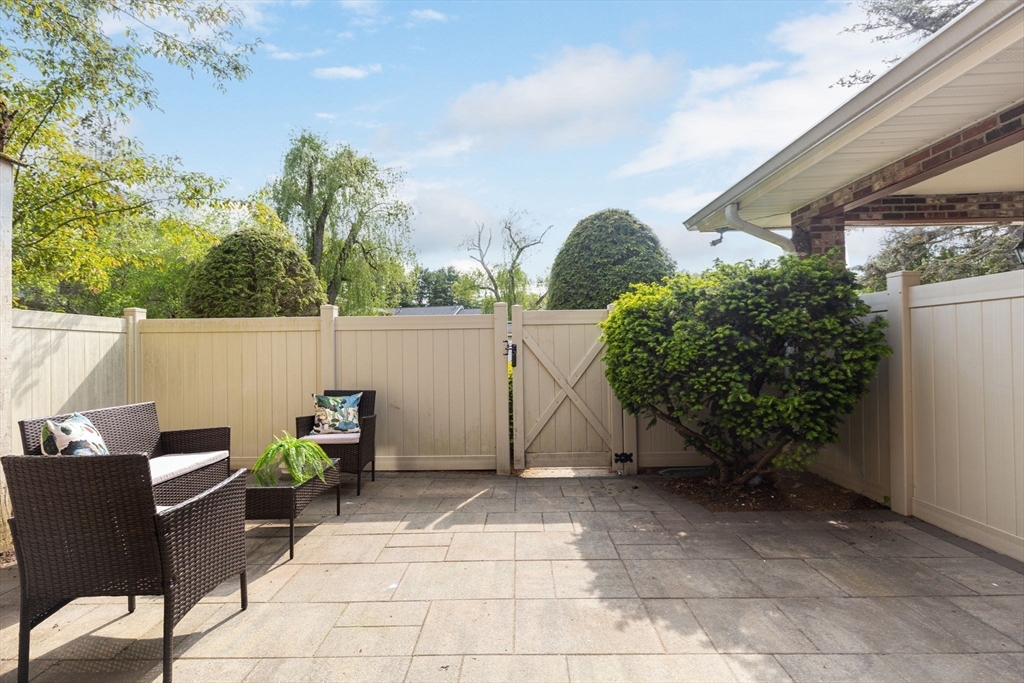 910 Edgell Road, Unit 914A Framingham, MA 01701 - Photo 11 of 22 a view of a chairs and table in backyard