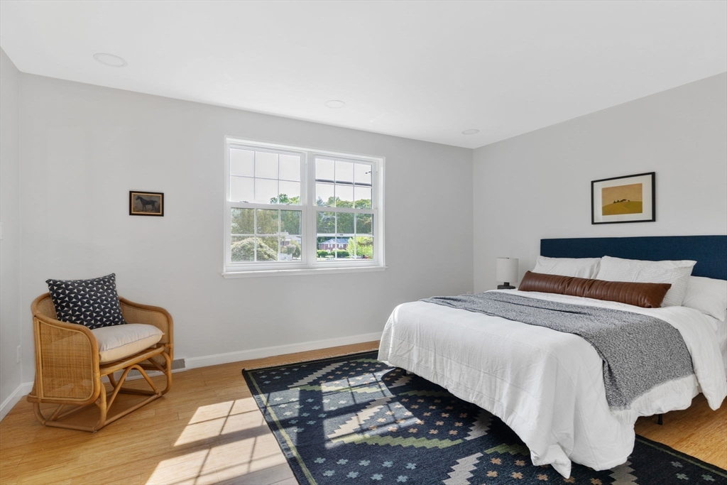 910 Edgell Road, Unit 914A Framingham, MA 01701 - Photo 17 of 22 a bedroom with a bed and chair