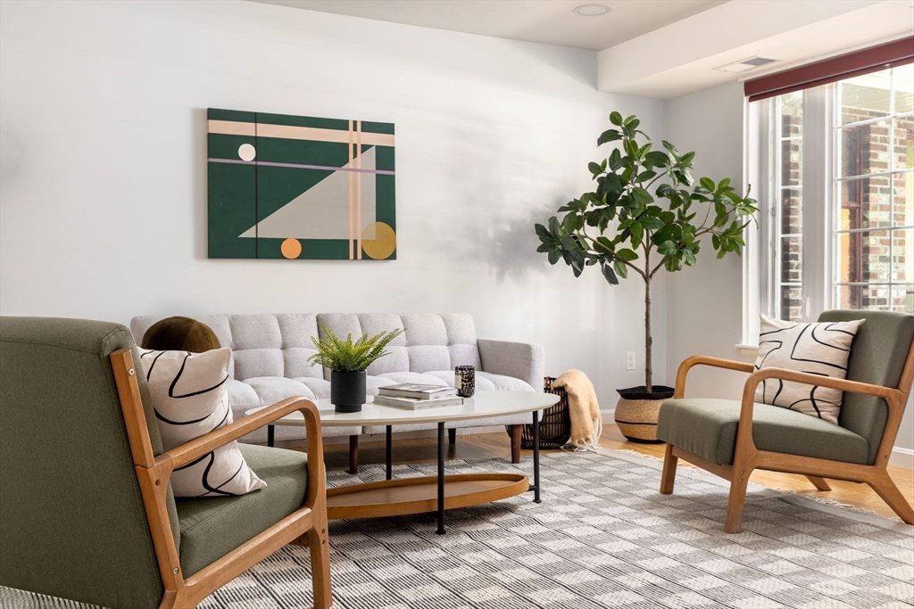 910 Edgell Road, Unit 914A Framingham, MA 01701 - Photo 3 of 22 a living room with furniture and a potted plant