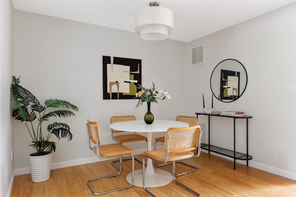 910 Edgell Road, Unit 914A Framingham, MA 01701 - Photo 5 of 22 a dining room with furniture and a mirror