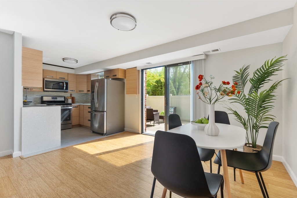 910 Edgell Road, Unit 914A Framingham, MA 01701 - Photo 8 of 22 a kitchen with stainless steel appliances a table and chairs