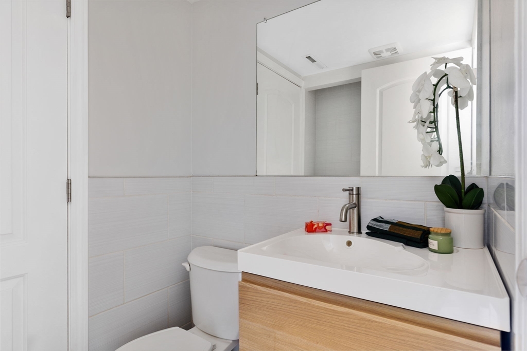 910 Edgell Road, Unit 914A Framingham, MA 01701 - Photo 10 of 22 a bathroom with a sink a toilet and a mirror