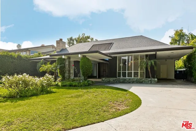 a view of a white house with swimming pool in front of it