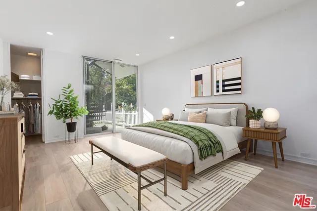 a bedroom with a bed and a potted plant