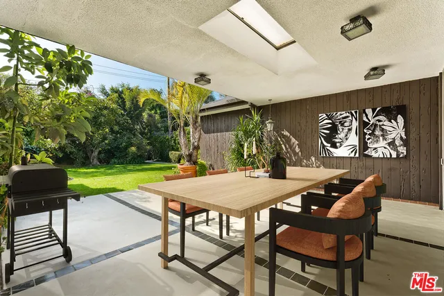 a view of a patio with a table and chairs