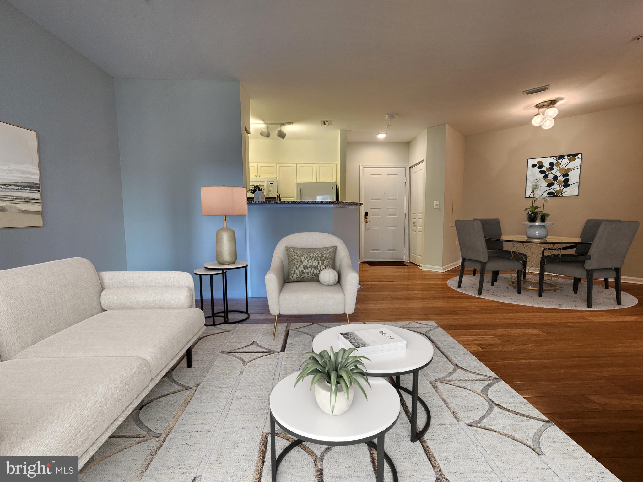 a living room with furniture and a dining table