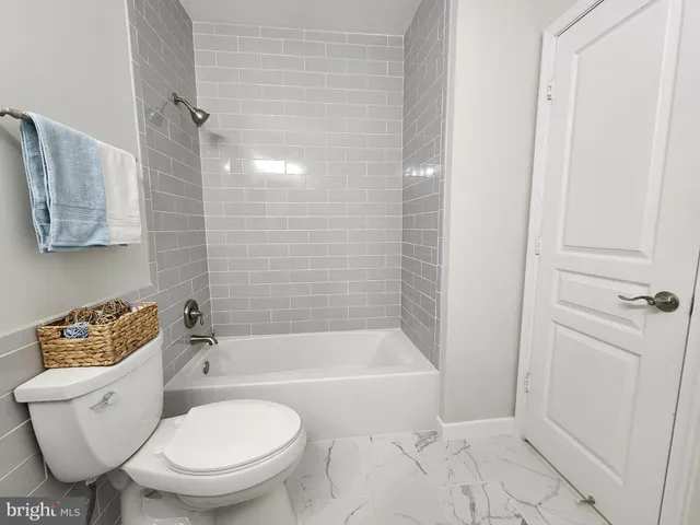 a bathroom with a toilet and a bathtub