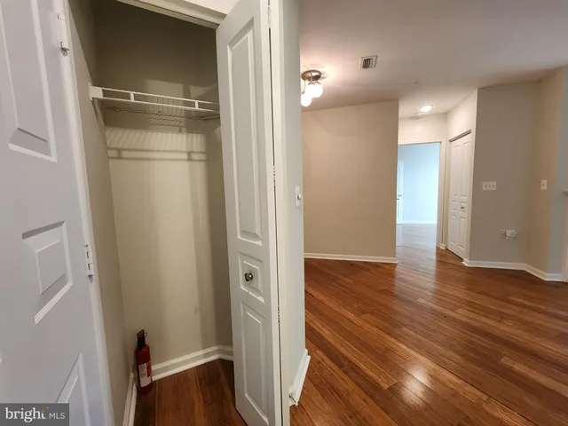 a view of empty room with wooden floor