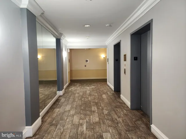 a view of a hallway with wooden floor
