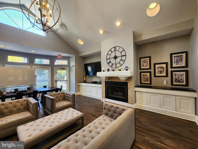 a living room with furniture a fireplace and wooden floor