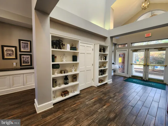 a view of a big room with wooden floor and windows