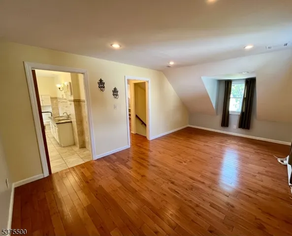 a bathroom with a granite countertop sink a mirror and tub