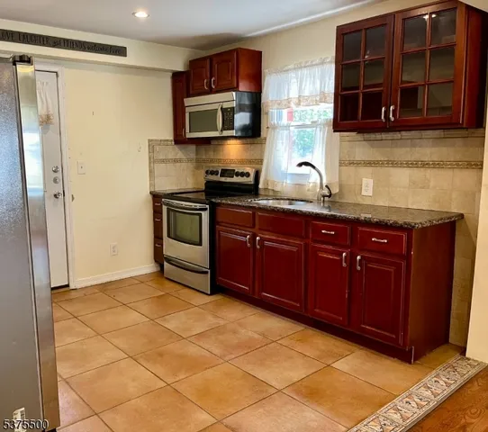 a kitchen with refrigerator and window