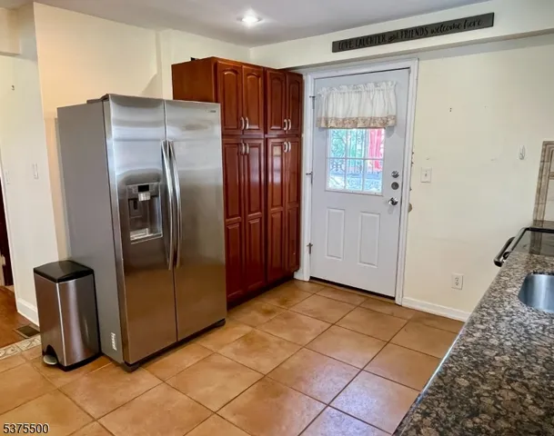 a view of a hallway with wooden floor and a living room