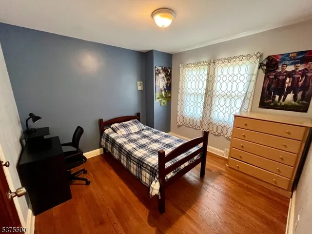 a view of a room with wooden floor and fan
