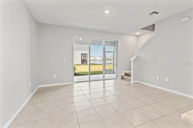 a living room with furniture a rug and white walls
