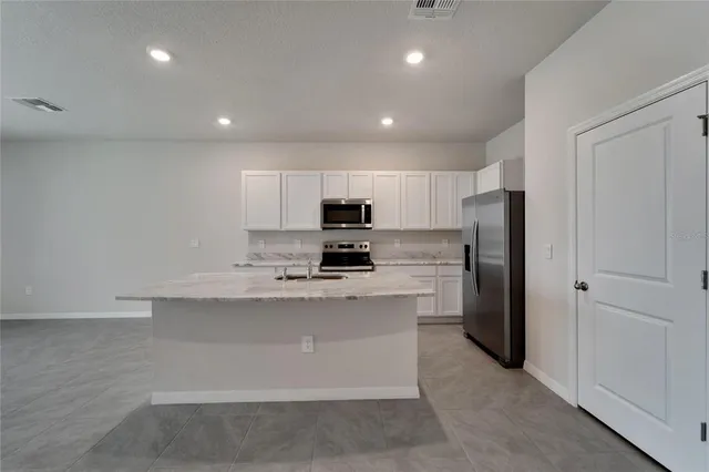 a kitchen with a sink stove and refrigerator