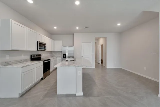 a kitchen with metallic refrigerator freezer and a dishwasher