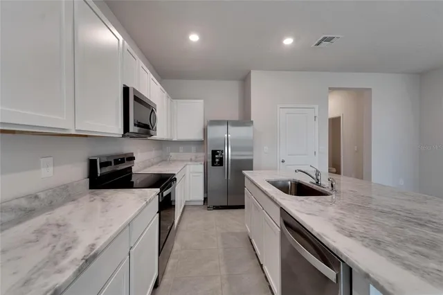 a kitchen with a stove and a sink