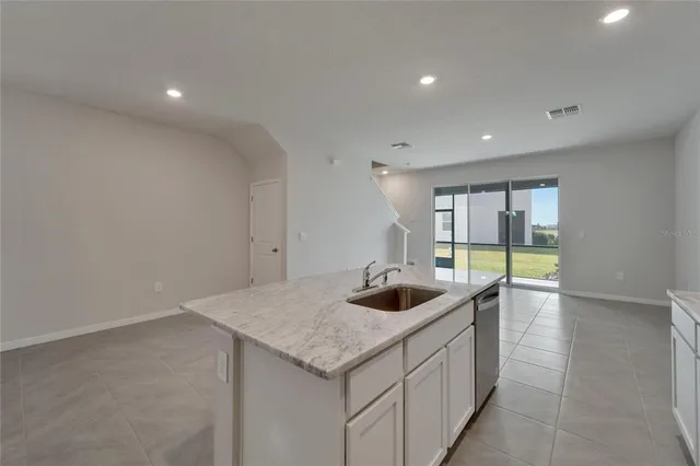 a kitchen with granite countertop a sink and a stove