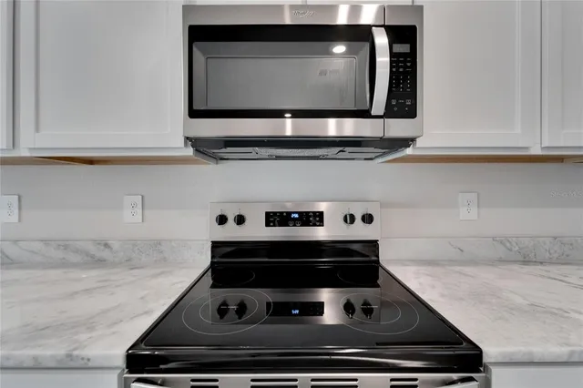 a kitchen with a refrigerator and cabinets