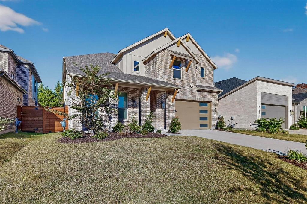 2017 Fall Crk Cove Mesquite, TX 75181 - Photo 9 of 40 View of front of property featuring driveway, brick siding, a porch, roof with shingles, and a garage