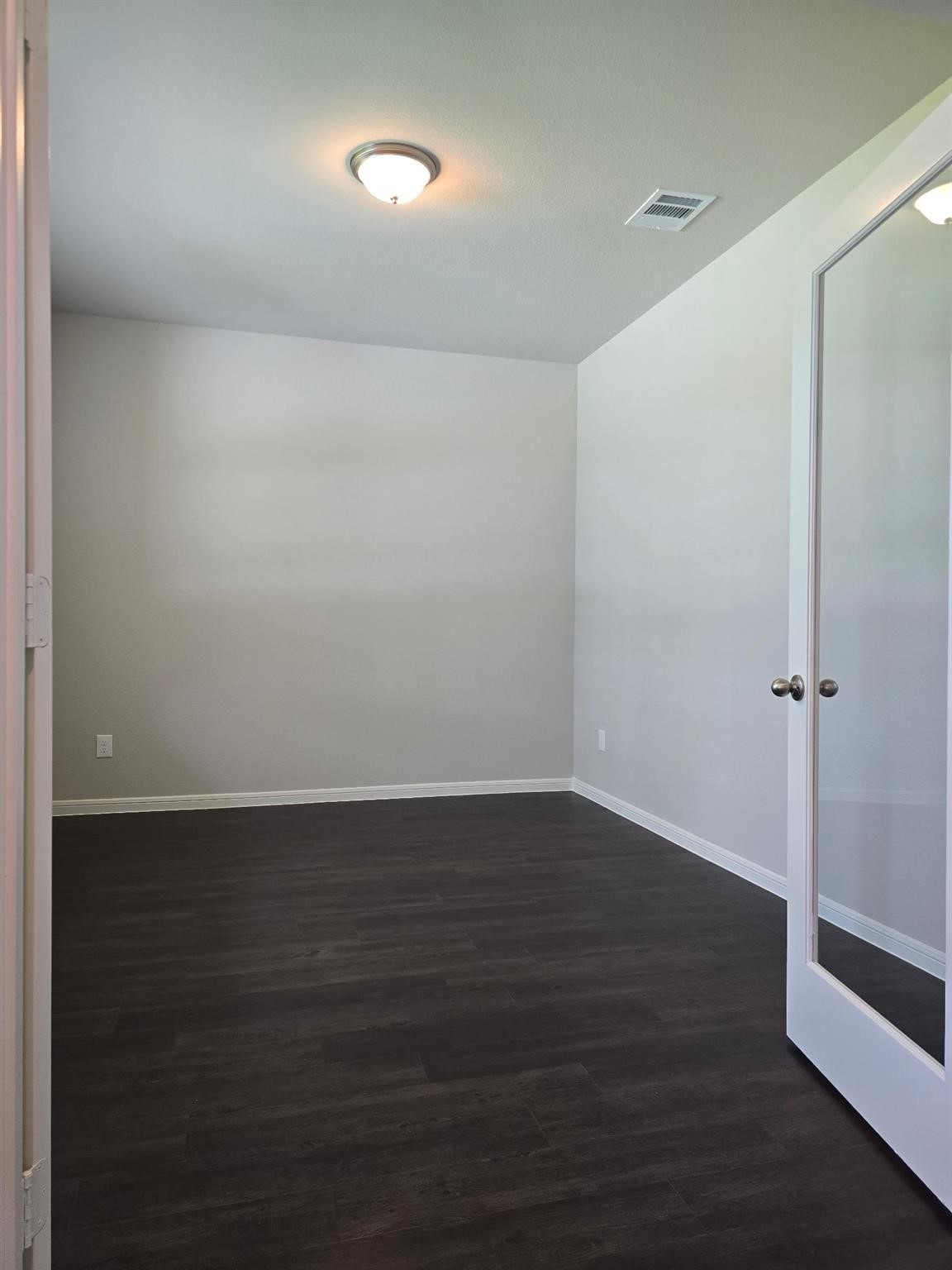 15905 Cy Young Court Splendora, TX 77372 - Photo 5 of 16 an empty room with wooden floor and windows