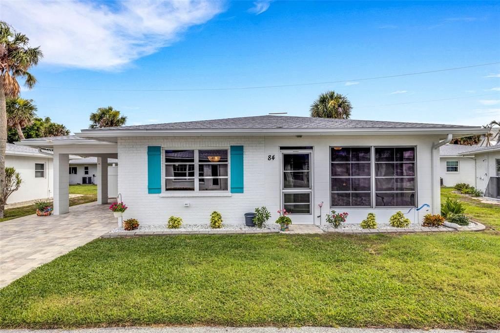 1977 Beach Road, Unit 84 Englewood, FL 34223 - Photo 1 of 42 a front view of a house with a yard