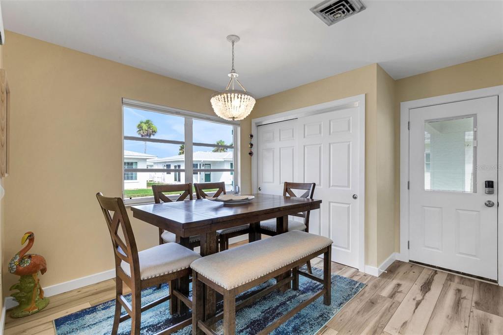 1977 Beach Road, Unit 84 Englewood, FL 34223 - Photo 12 of 42 a view of a dining room with furniture window and wooden floor