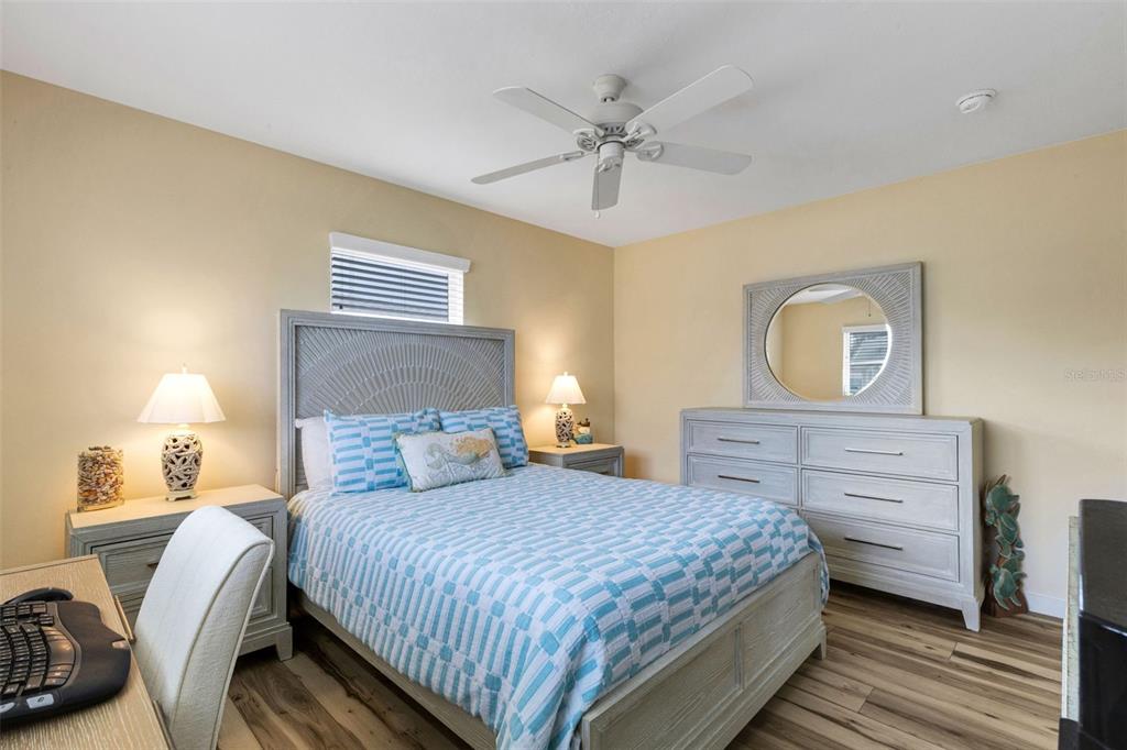 1977 Beach Road, Unit 84 Englewood, FL 34223 - Photo 15 of 42 a bedroom with a bed and a chandelier