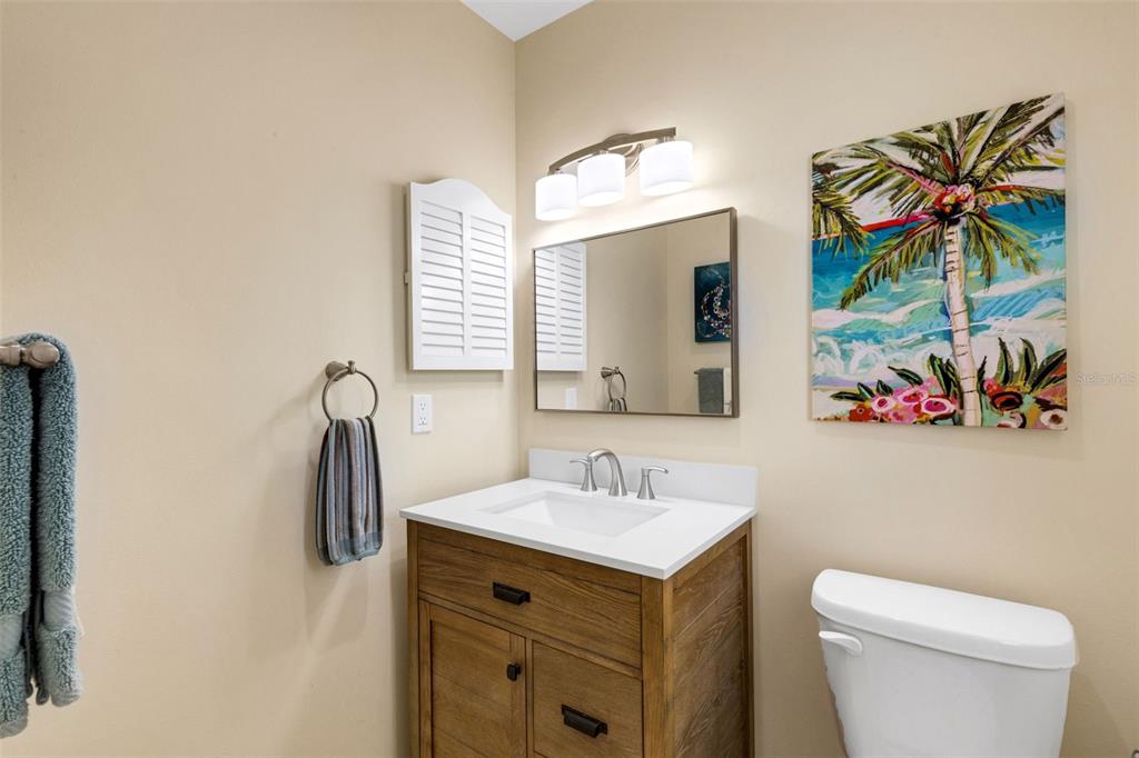 1977 Beach Road, Unit 84 Englewood, FL 34223 - Photo 21 of 42 a bathroom with a sink mirror and toilet