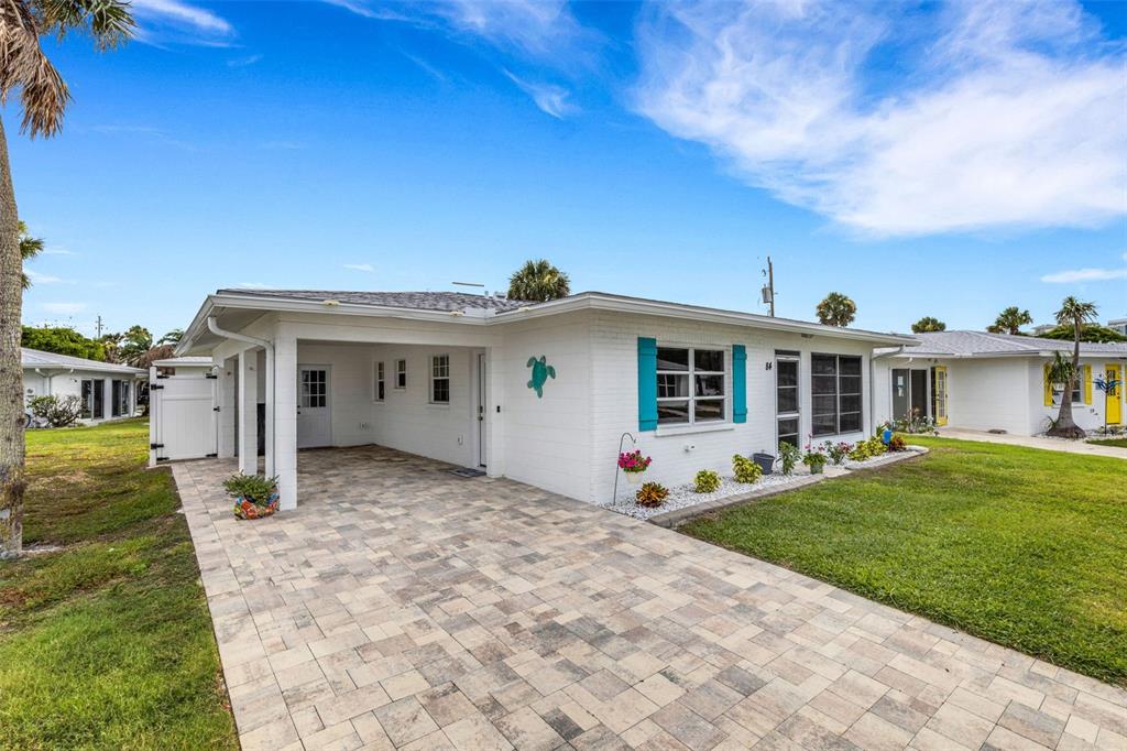 1977 Beach Road, Unit 84 Englewood, FL 34223 - Photo 26 of 42 a front view of a house with garden