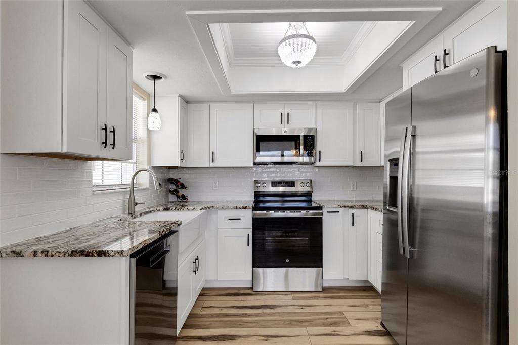 1977 Beach Road, Unit 84 Englewood, FL 34223 - Photo 6 of 42 a kitchen with stainless steel appliances granite countertop a stove a refrigerator and a sink