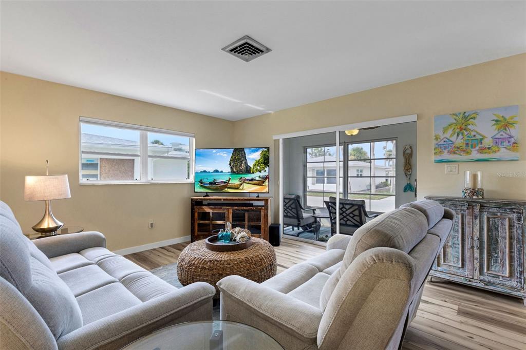 1977 Beach Road, Unit 84 Englewood, FL 34223 - Photo 8 of 42 a living room with furniture a window and a flat screen tv