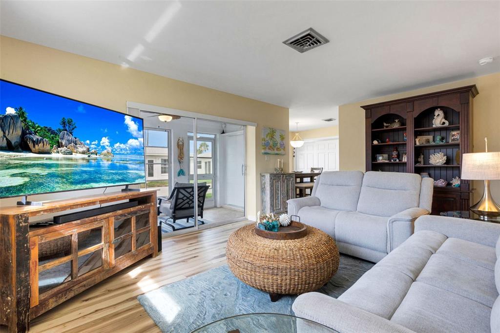 1977 Beach Road, Unit 84 Englewood, FL 34223 - Photo 9 of 42 a living room with furniture and a fireplace