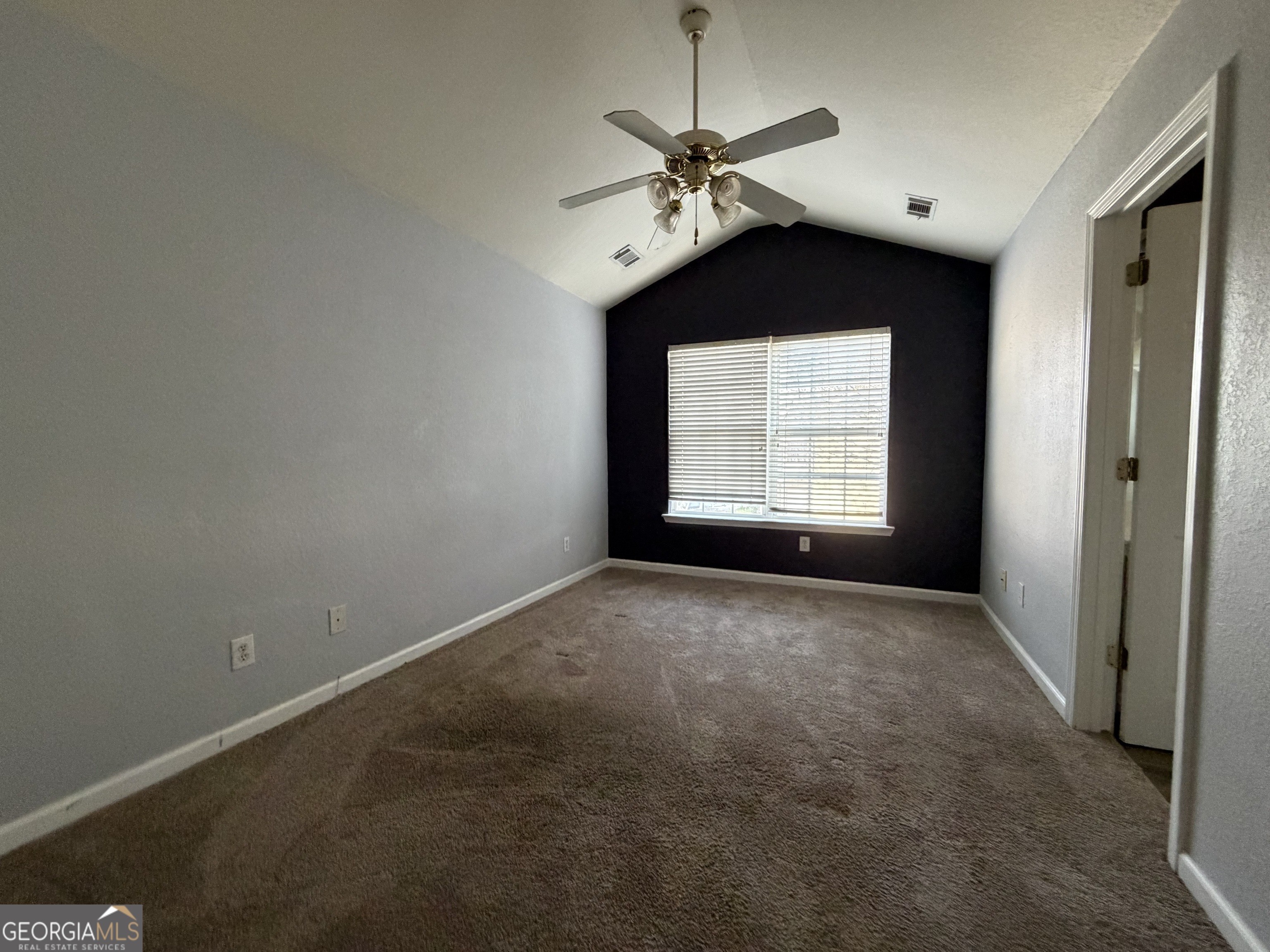 2807 Snapfinger Manor Decatur, GA 30035 - Photo 14 of 17 en empty room with windows and chandelier fan