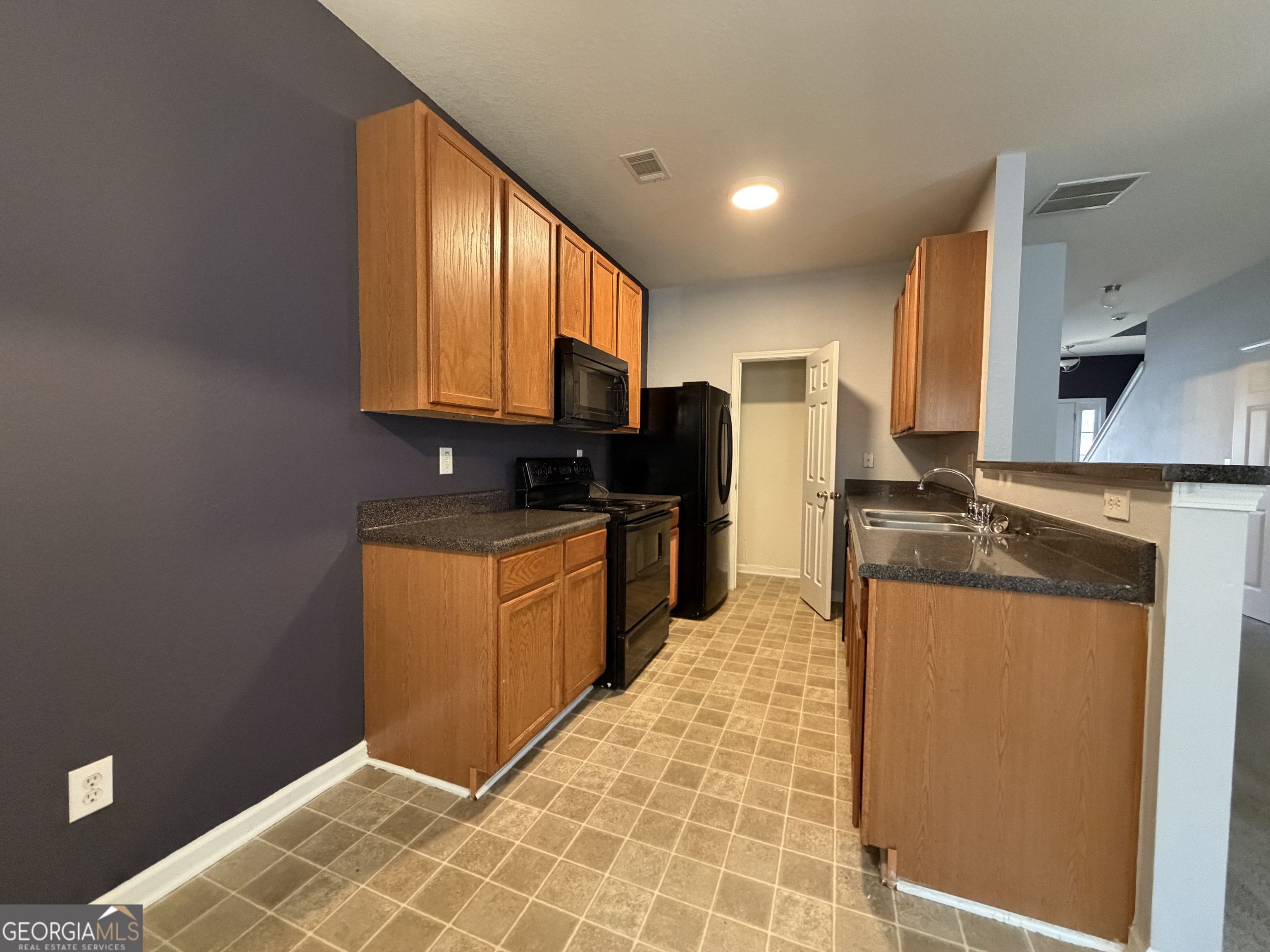 2807 Snapfinger Manor Decatur, GA 30035 - Photo 8 of 17 a kitchen with stainless steel appliances granite countertop a refrigerator a stove top oven and granite countertops