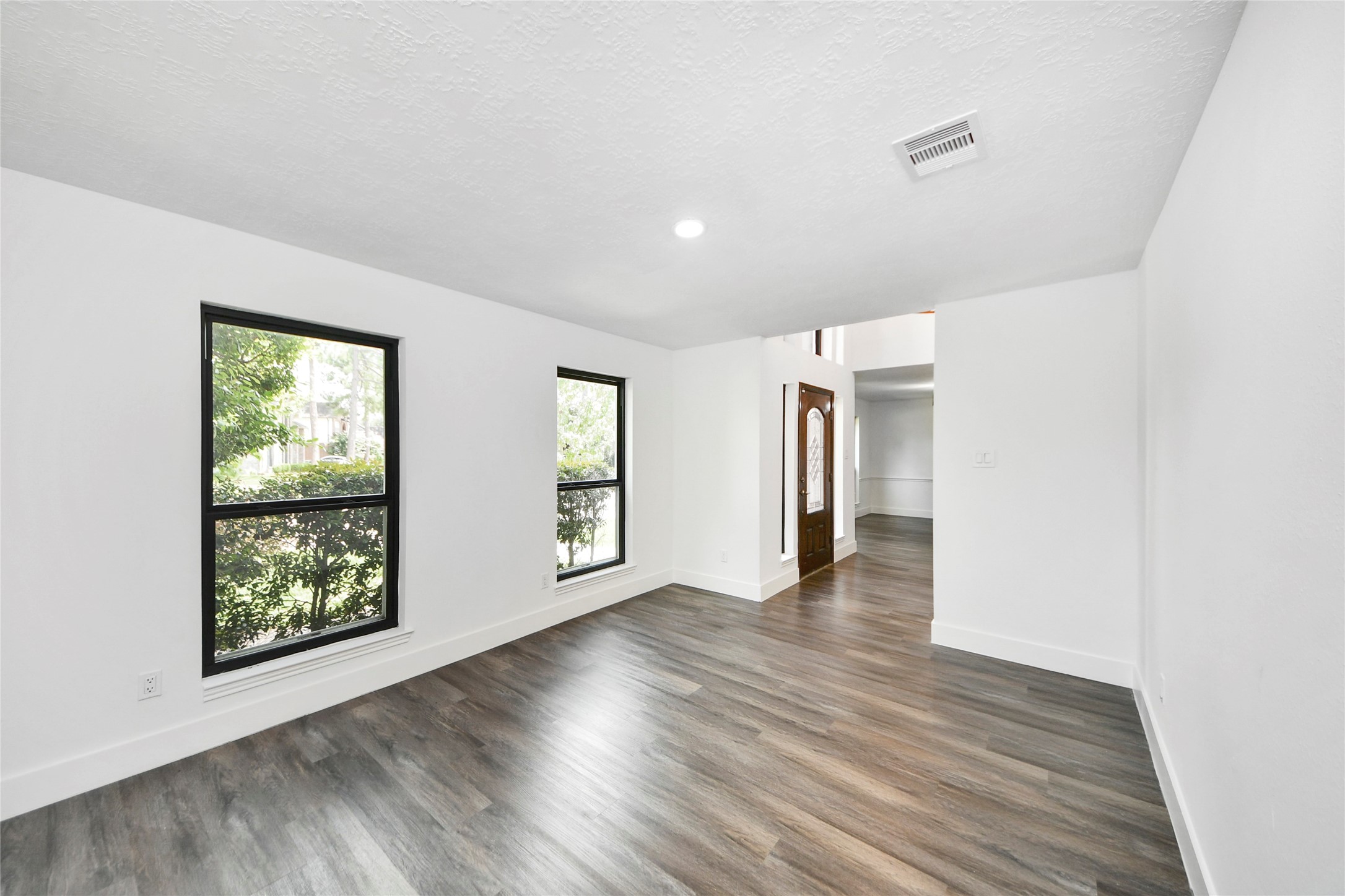 8510 Canyon Pine Drive Spring, TX 77379 - Photo 20 of 42 an empty room with wooden floor and windows