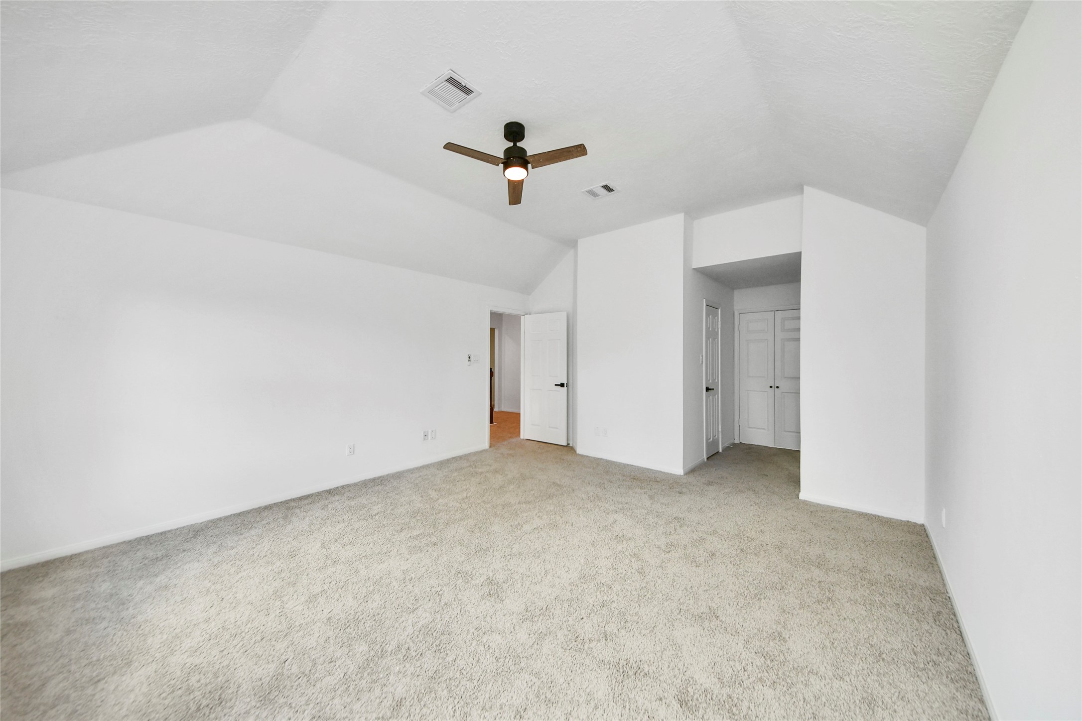 8510 Canyon Pine Drive Spring, TX 77379 - Photo 24 of 42 an empty room with a ceiling fan and carpet