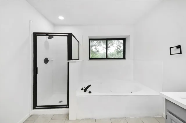 a bathroom with a bathtub and shower