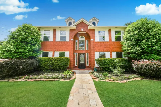 a front view of a house with garden