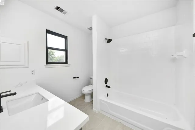 a bathroom with a bathtub and a toilet
