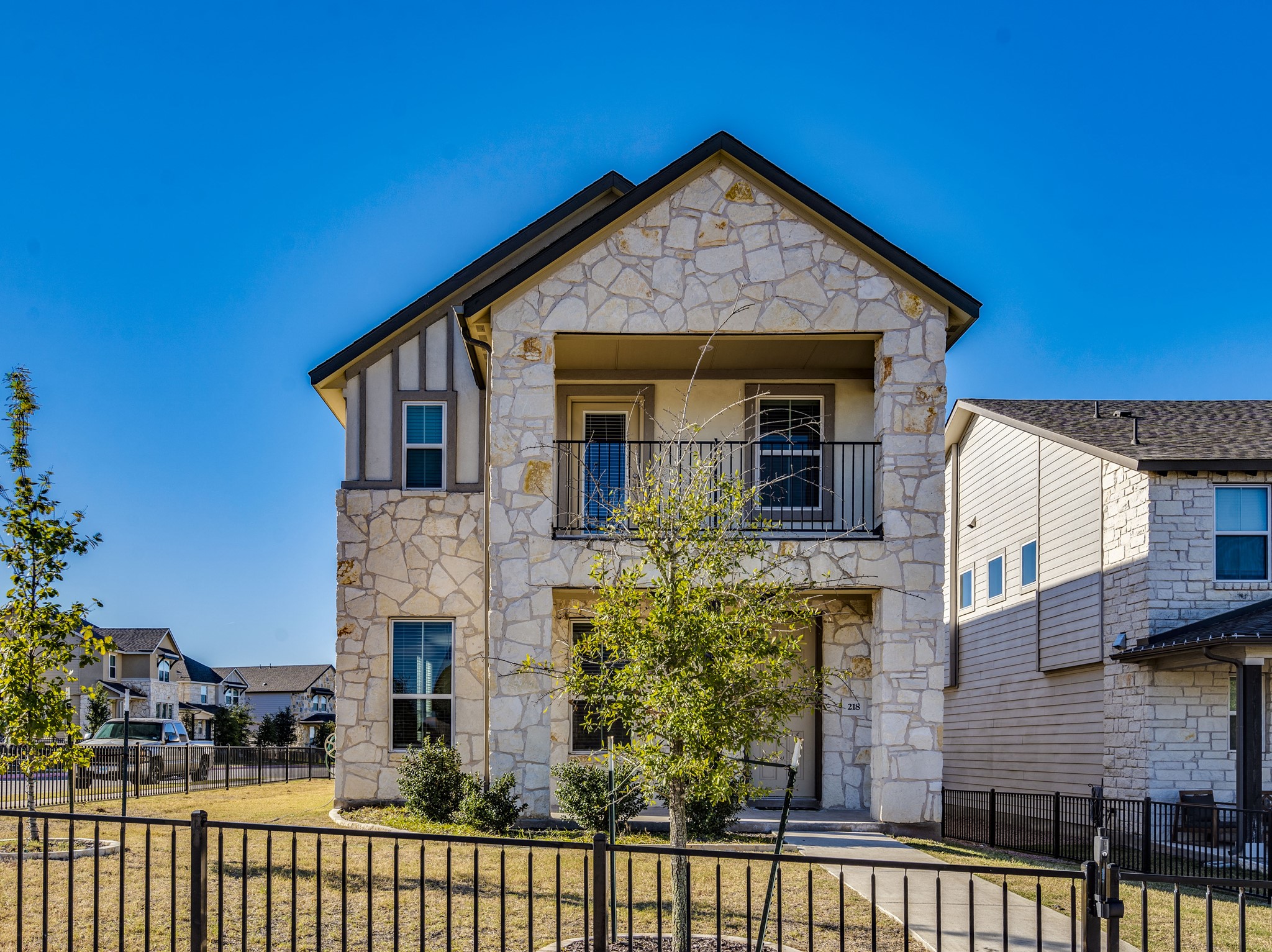 a front view of a house with a garden