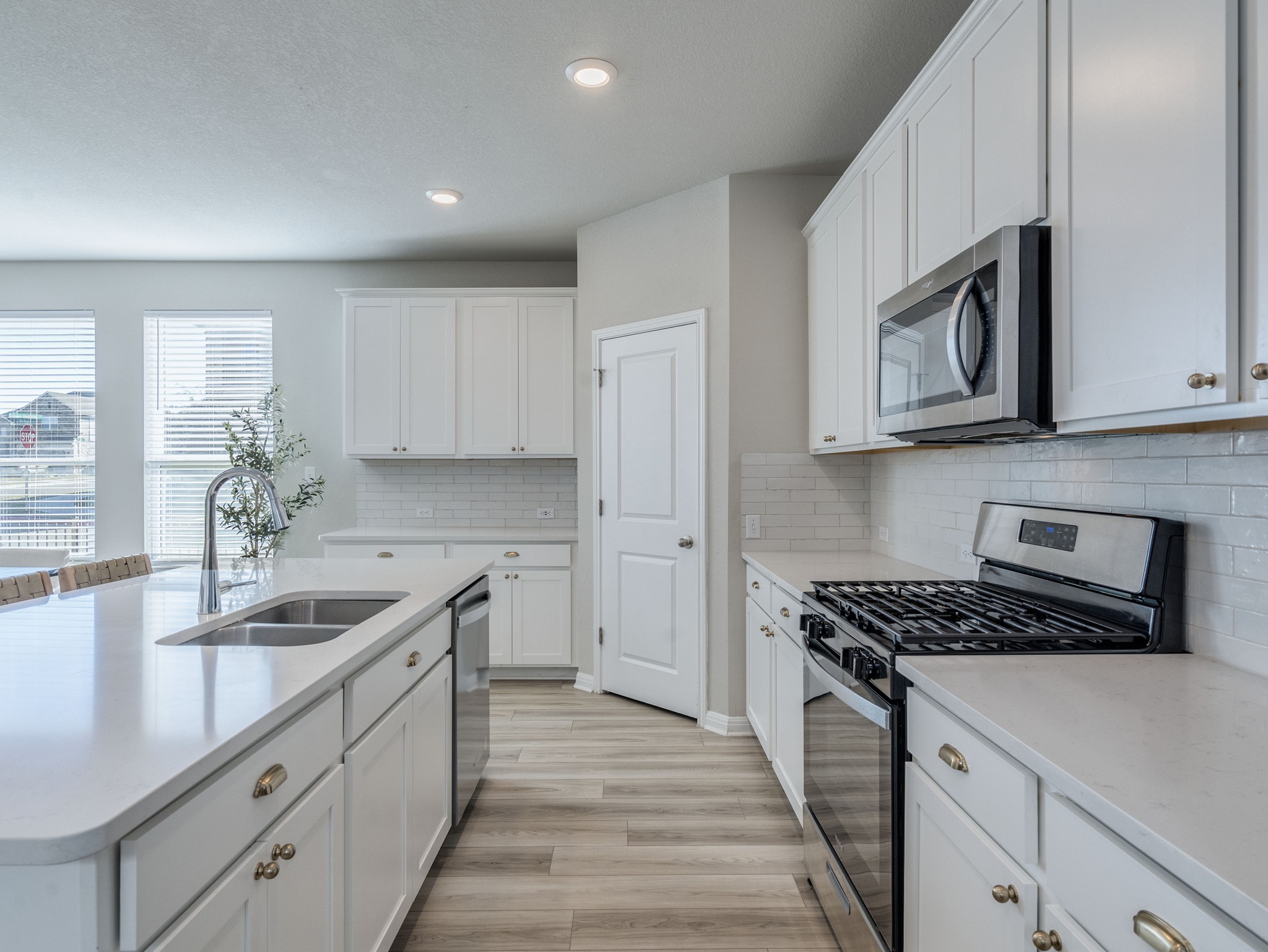 218 Glass Mountain Way Dripping Springs, TX 78620 - Photo 12 of 29 a kitchen with granite countertop a sink stove and cabinets