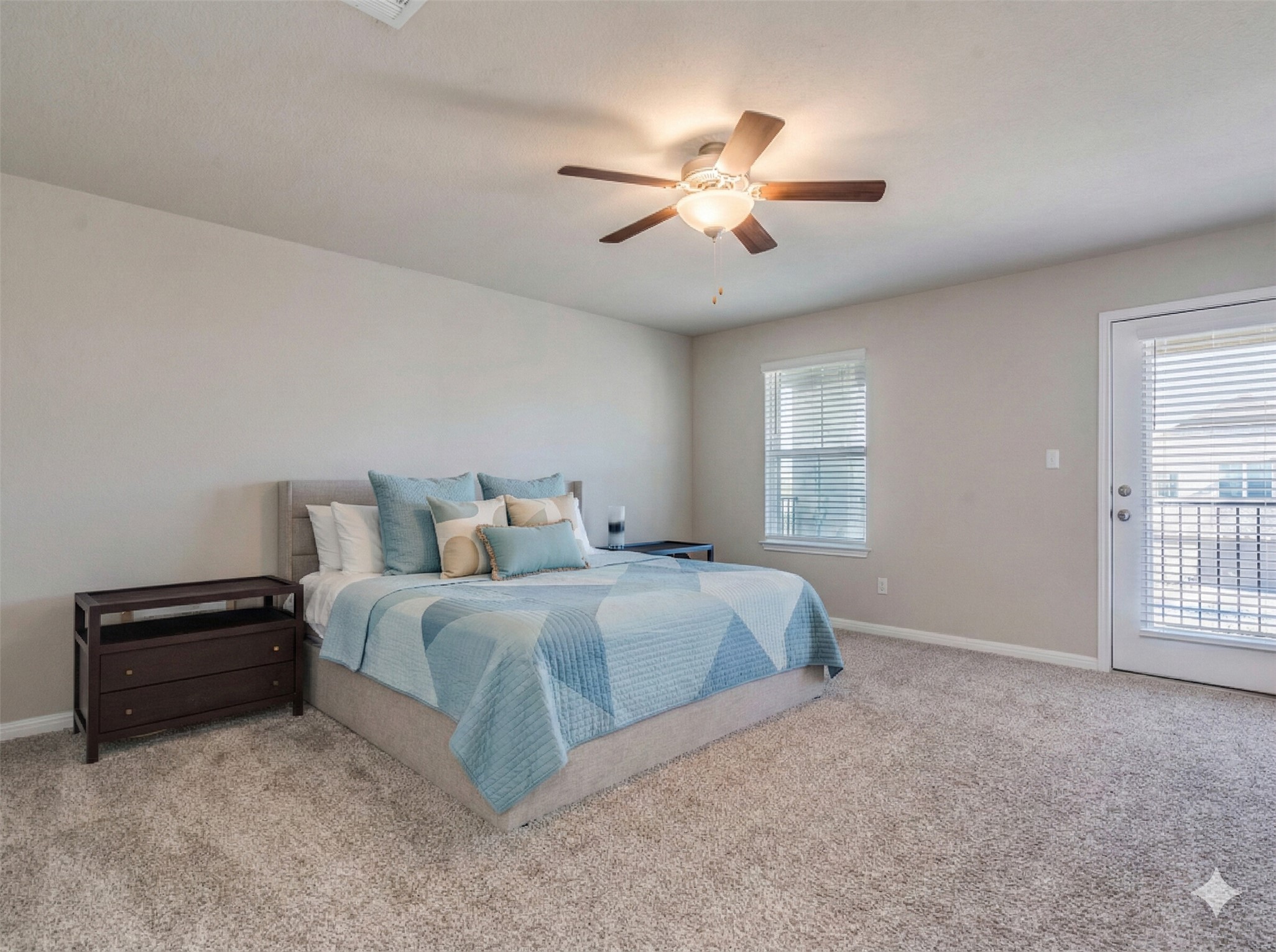 218 Glass Mountain Way Dripping Springs, TX 78620 - Photo 18 of 29 a spacious bedroom with a bed and a chandelier