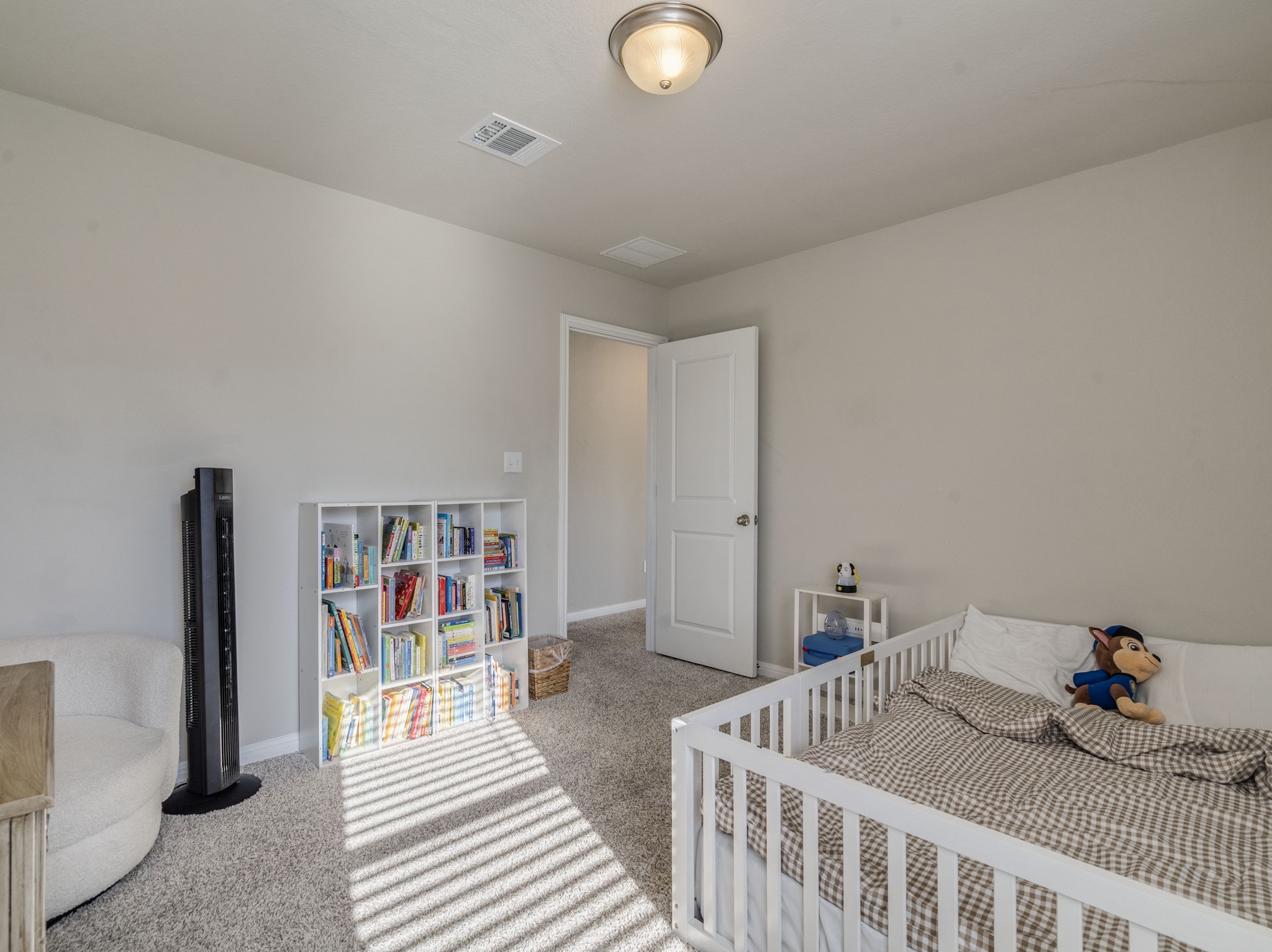 218 Glass Mountain Way Dripping Springs, TX 78620 - Photo 22 of 29 a bedroom with furniture and a book shelf