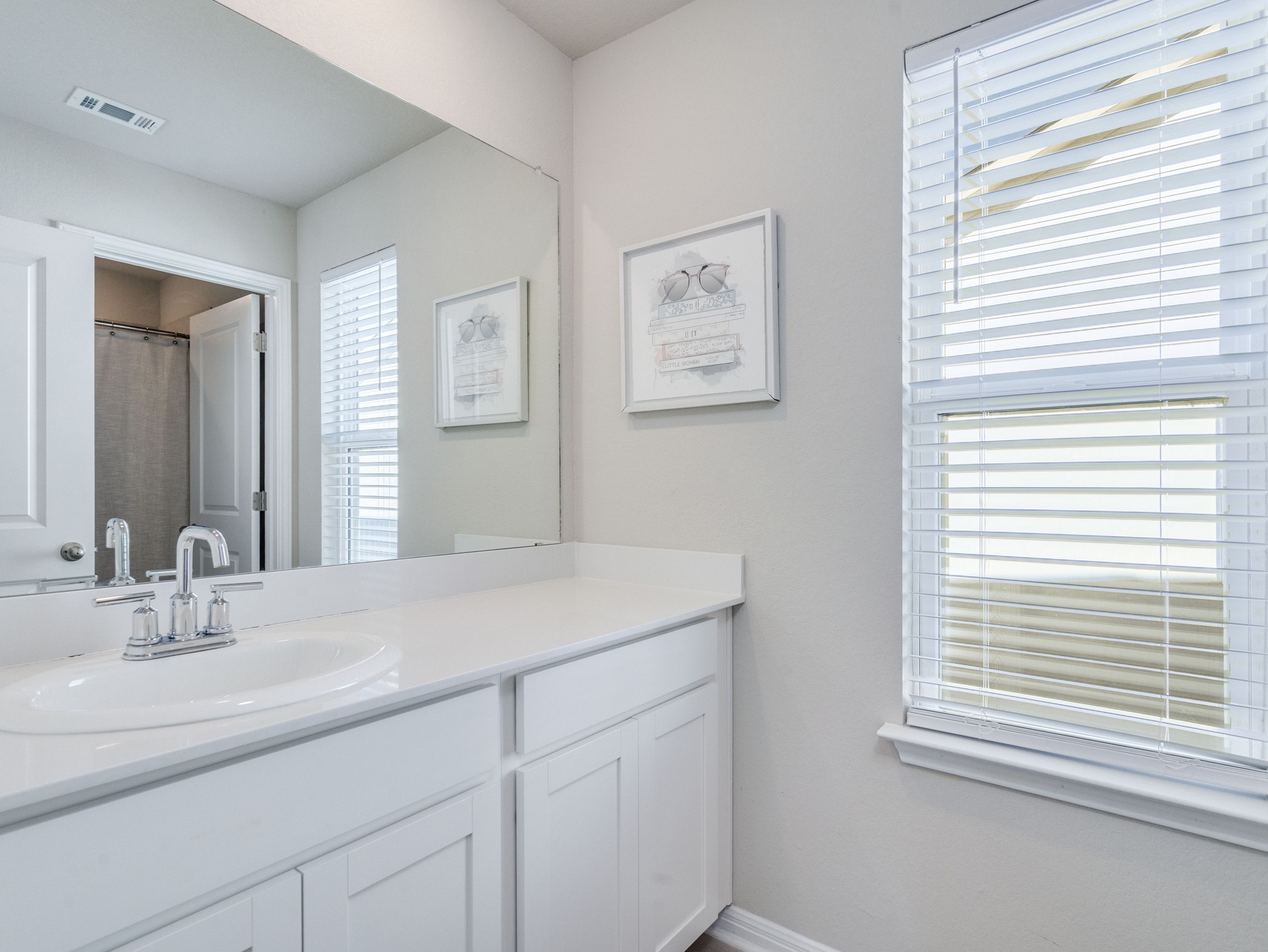 218 Glass Mountain Way Dripping Springs, TX 78620 - Photo 25 of 29 a bathroom with a sink and a mirror