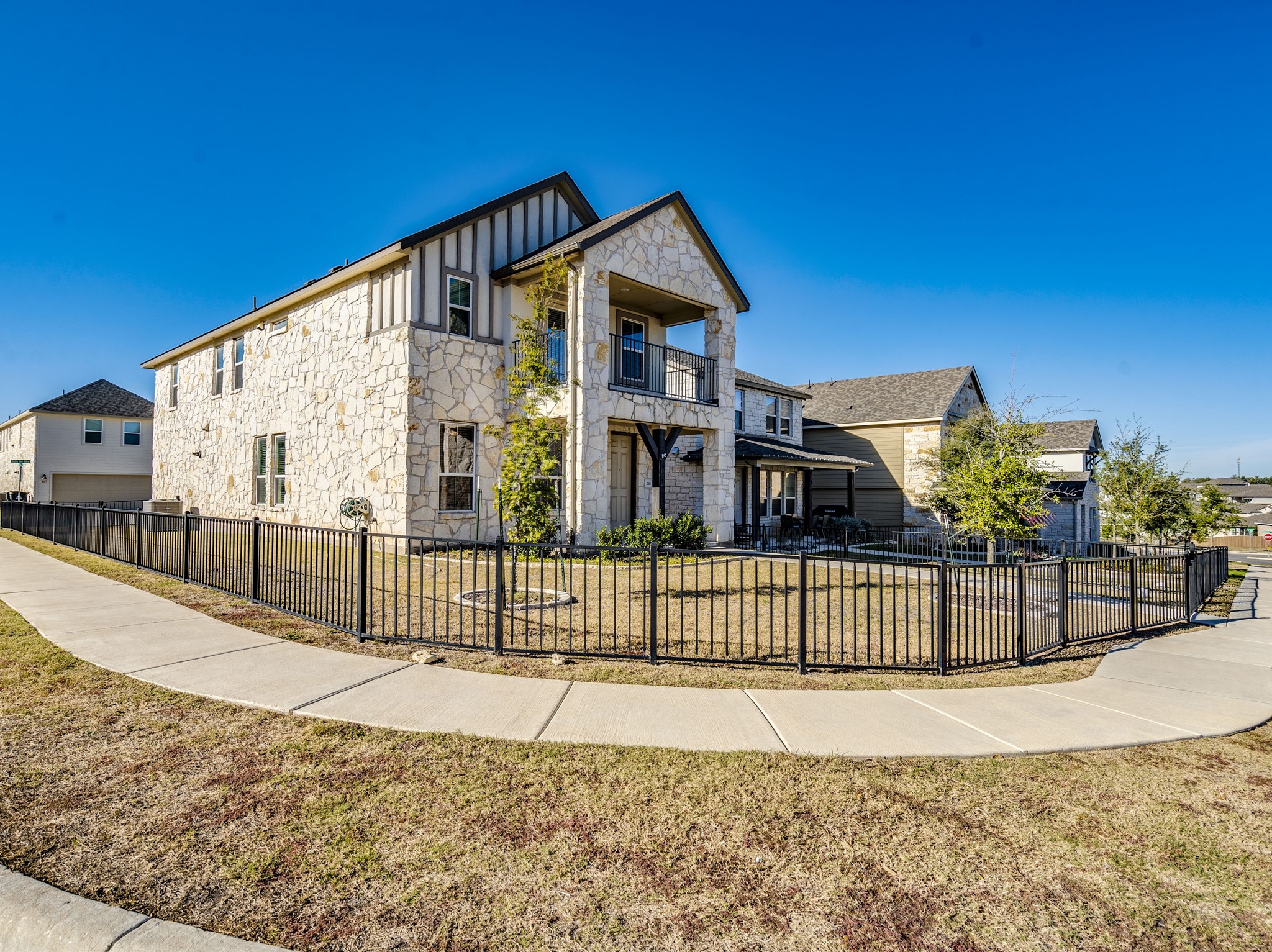 218 Glass Mountain Way Dripping Springs, TX 78620 - Photo 6 of 29 a view of a house with a wooden fence